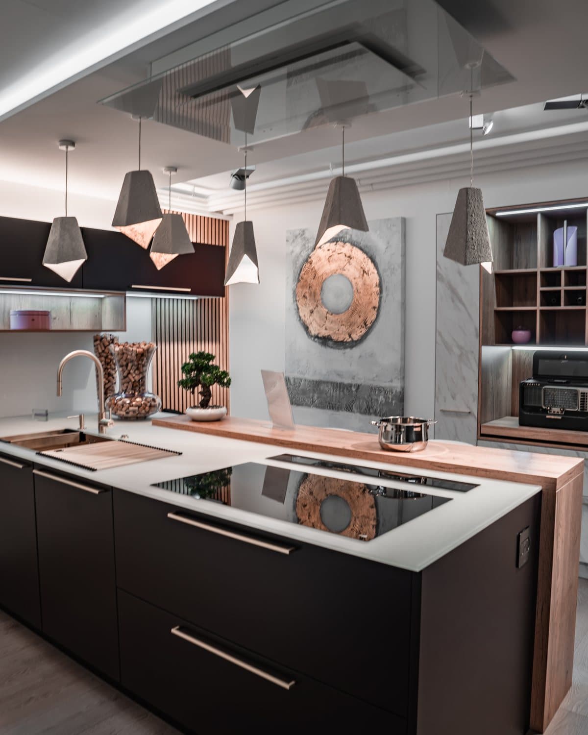 Îlot central noir mat et plan de travail clair dans le showroom Teutschmann à Nyon