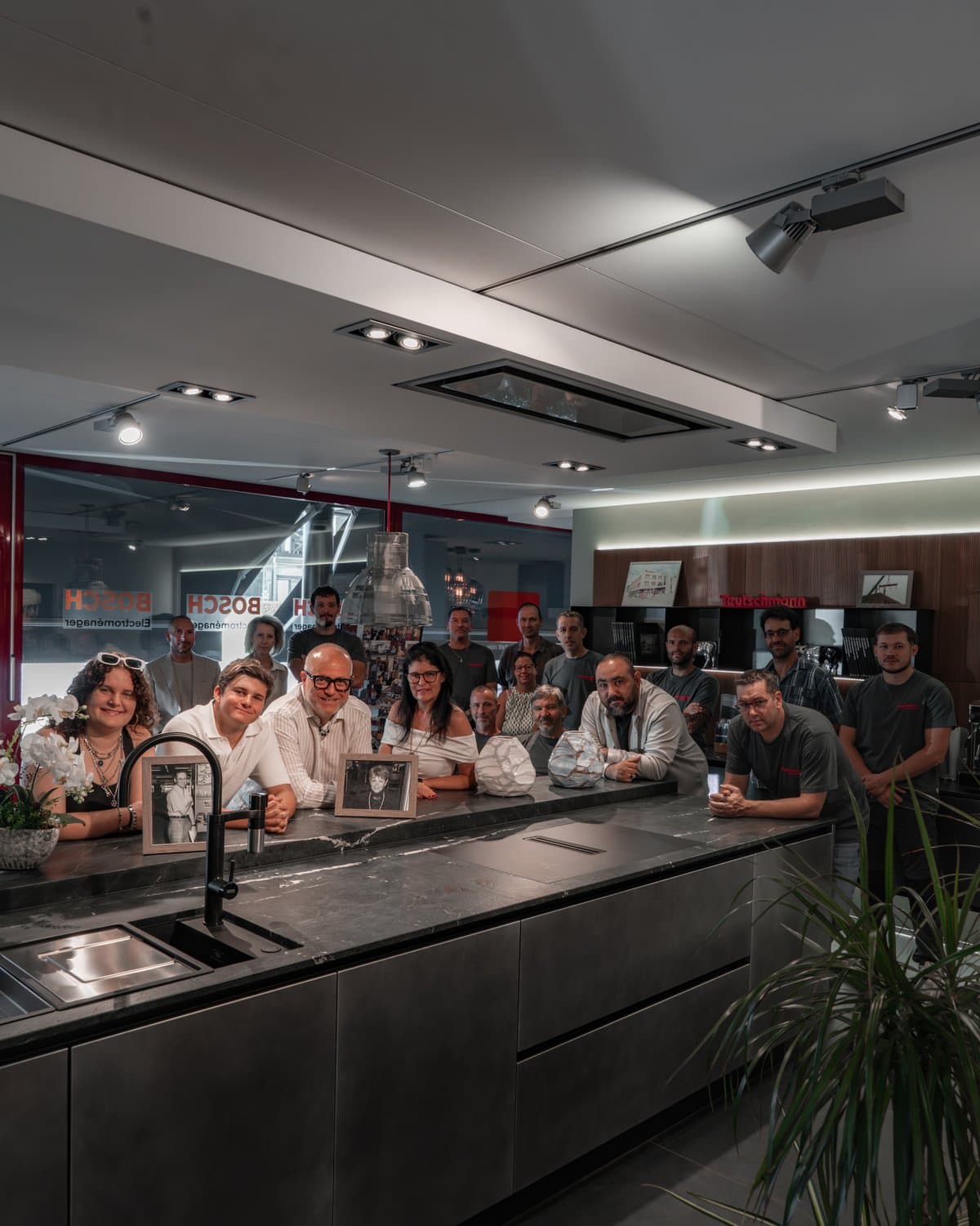 The Teutschmann team gathered behind the showroom island in Nyon